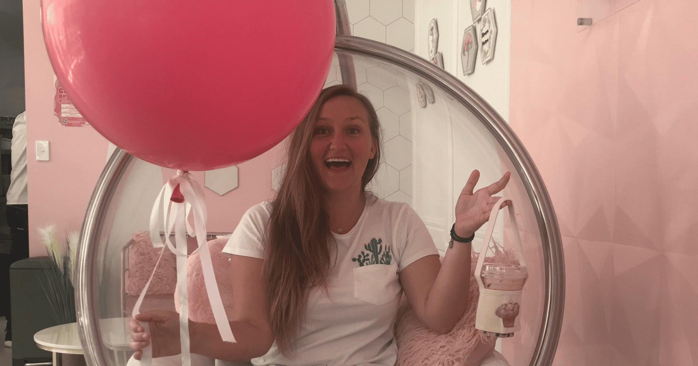 Woman holding Giant Pink Balloon and Bubble Tea