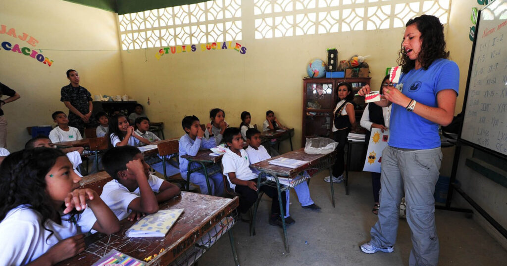 Woman teaching English to children