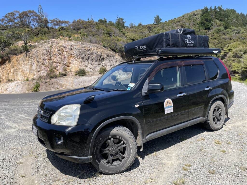 Rooftop tent camping car with tent down