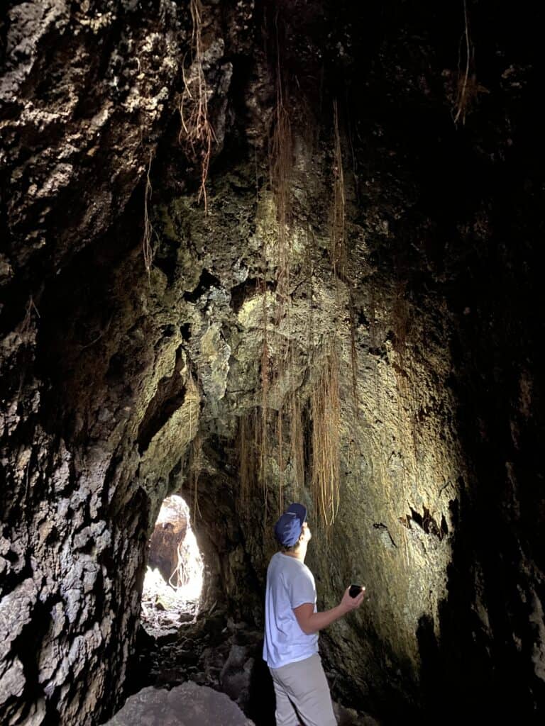 Man looking through a lava cave