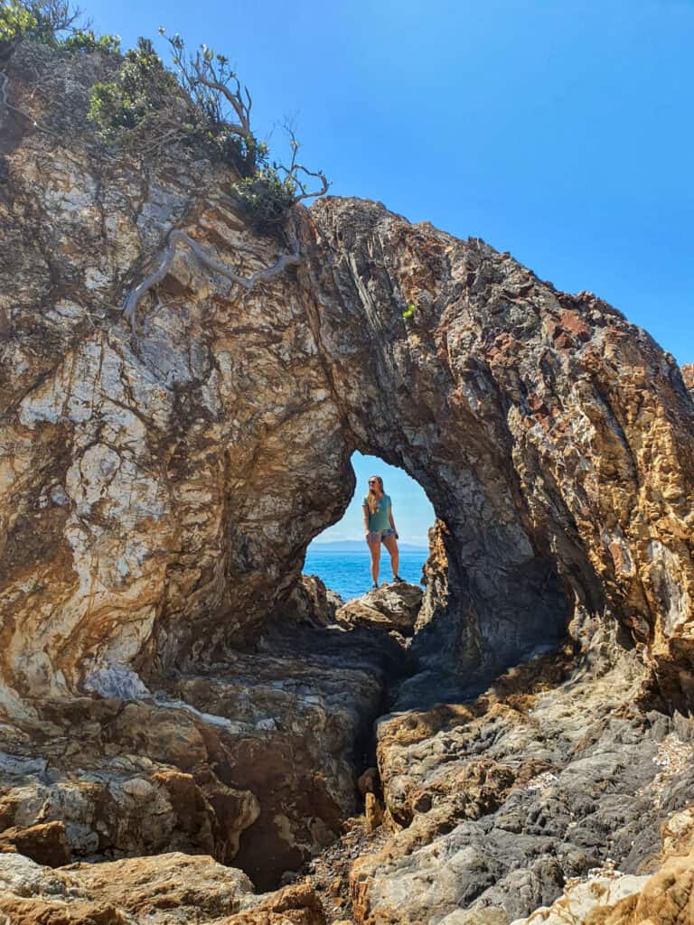 Hole in a rock framing a person