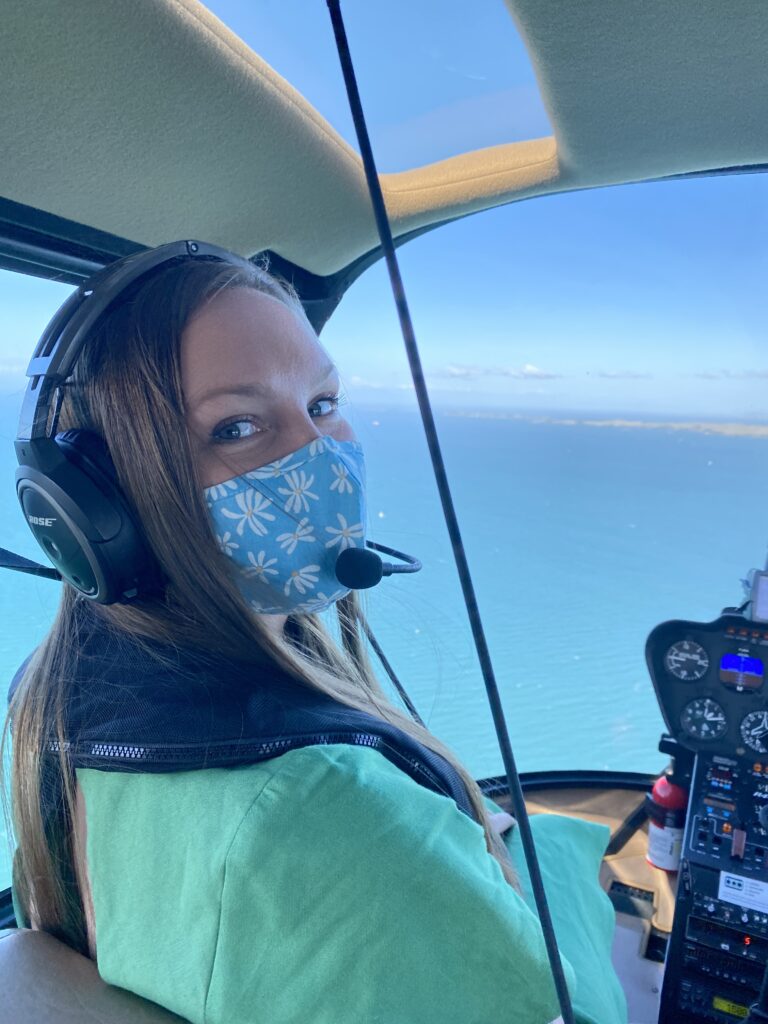 Girl in a helicopter going to one of the top island getaways near Auckland. Waiheke