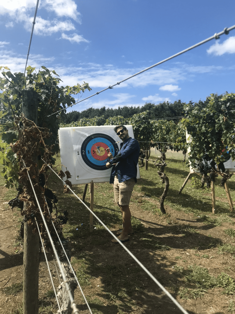 Man next to an archery bullseye