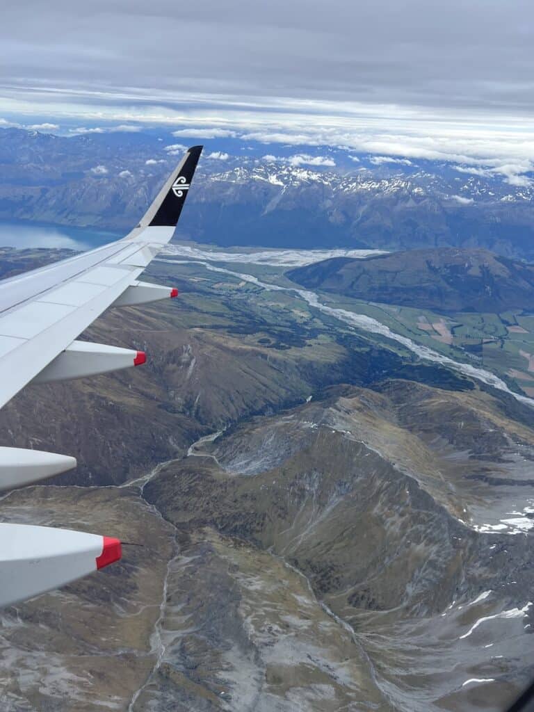 Air New Zealand plane wing looking out over the mountains in Queenstown