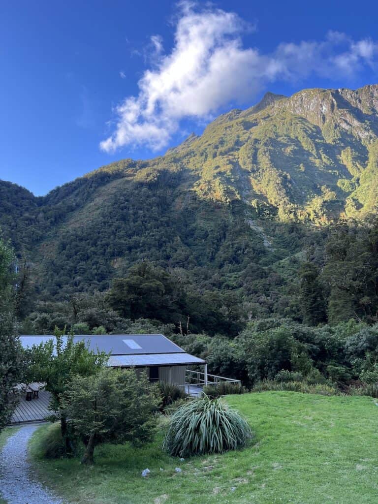 Wooden hut with the morning sun shining on the mountains