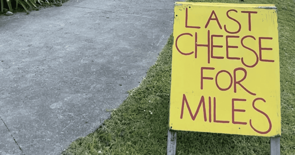 Sign that reads Last Cheese for Miles