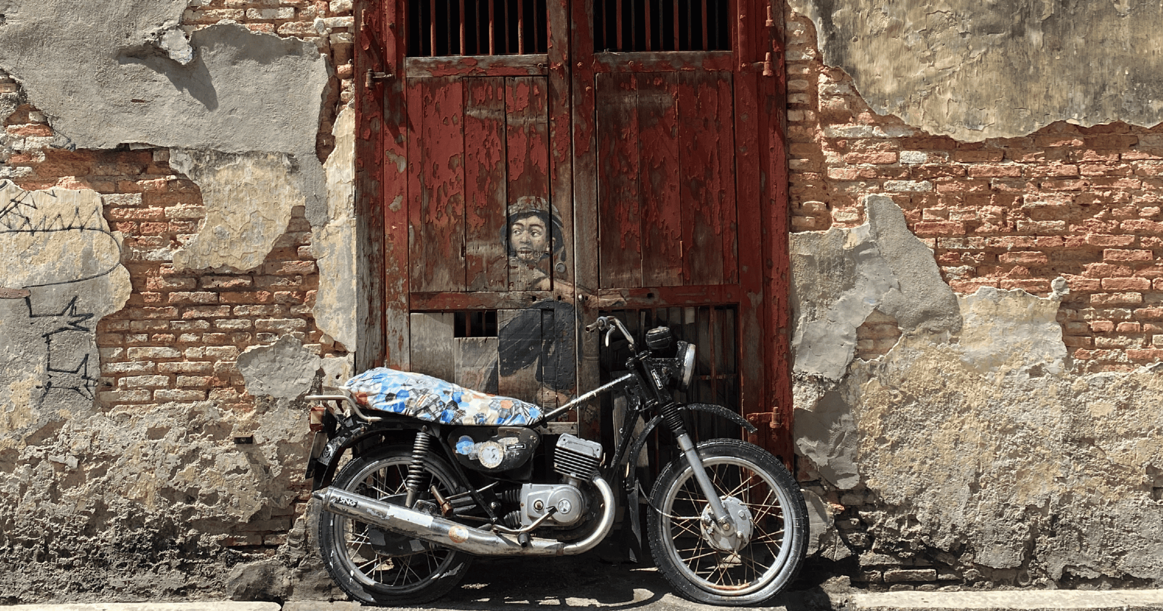 Street Art of Boy on a Motorcycle in Penang Malaysia