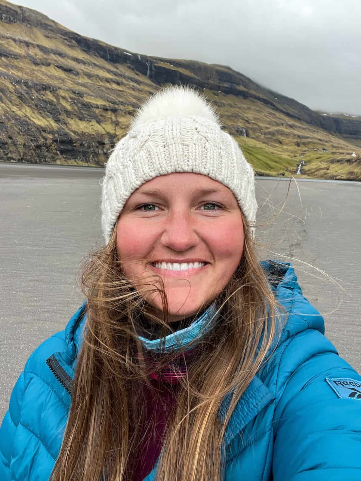 Woman in winter clothing on a Faroe Islands beach