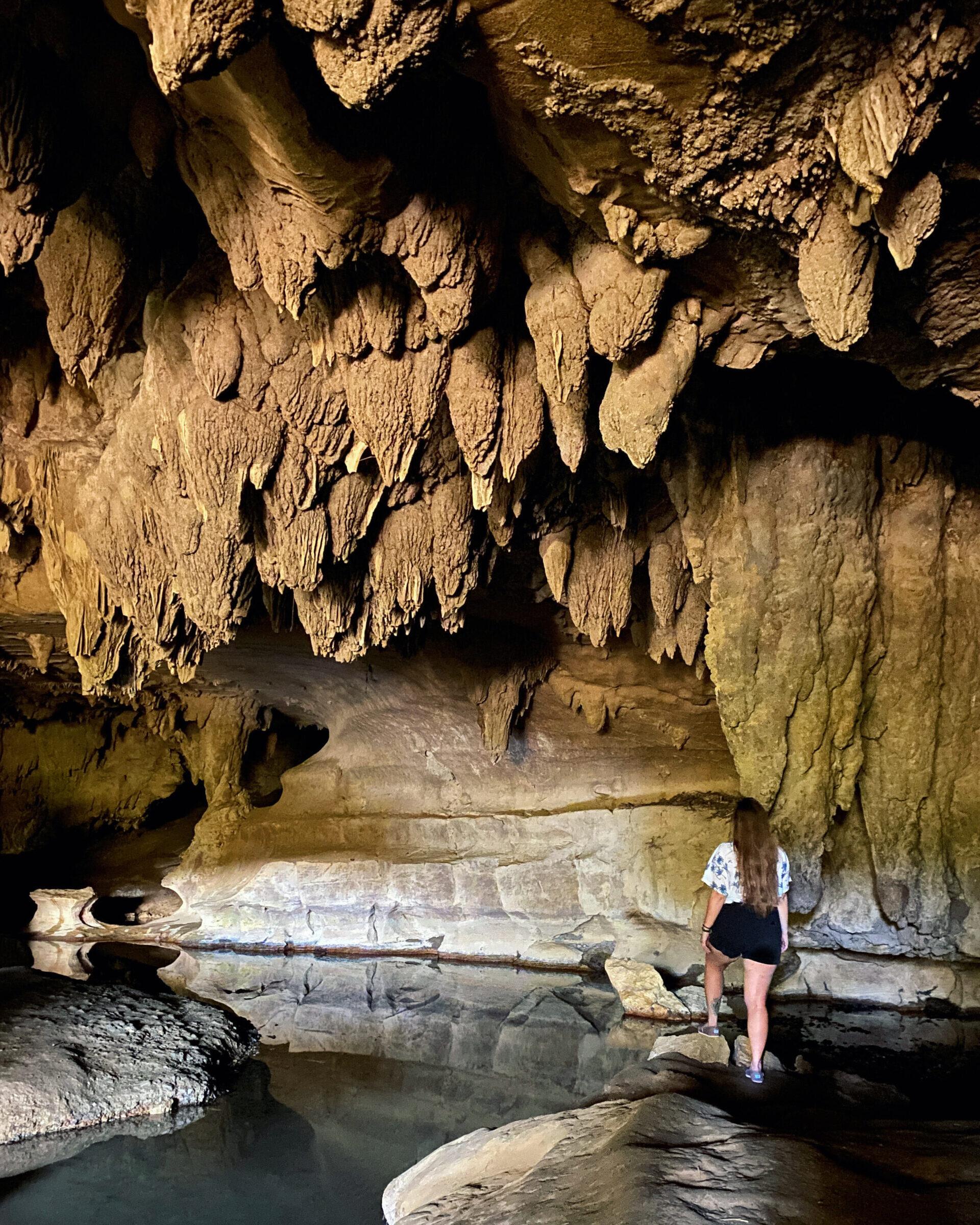 Girl Standing in Waipu Caves with stalactites