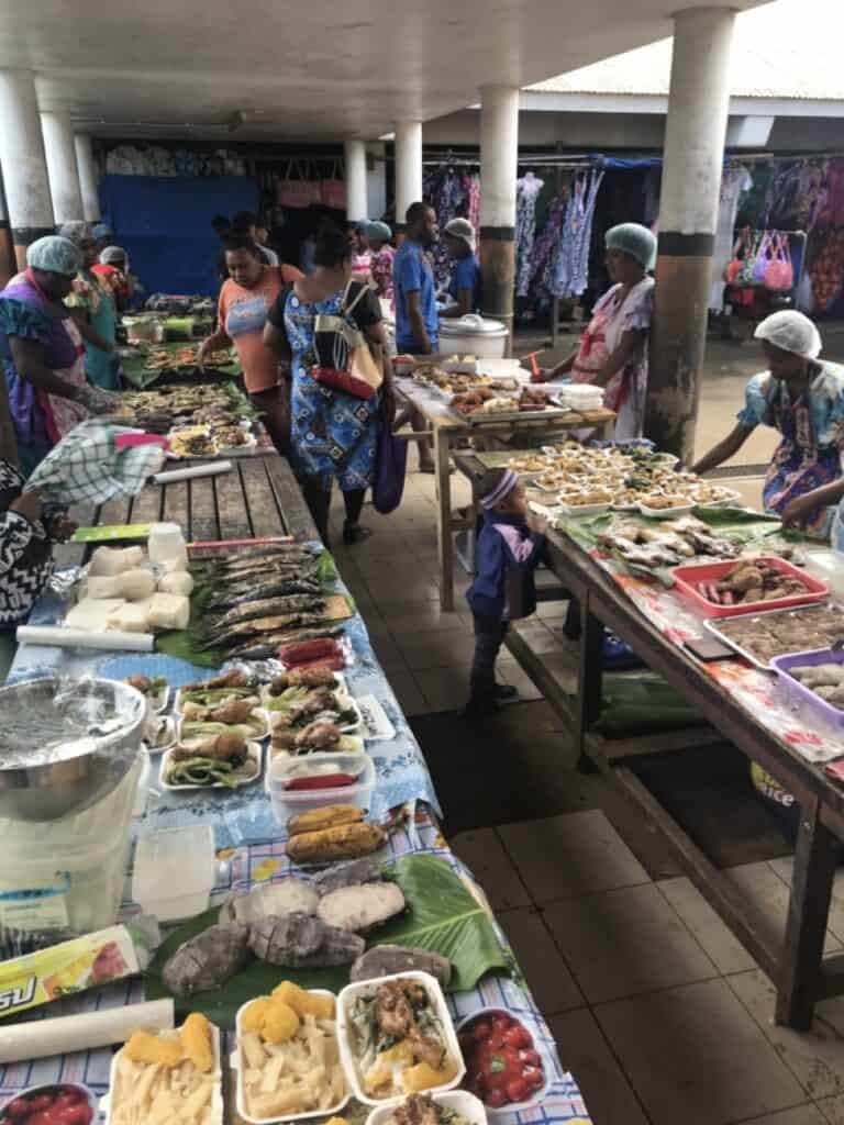 Market stalls selling fruit and sandwiches