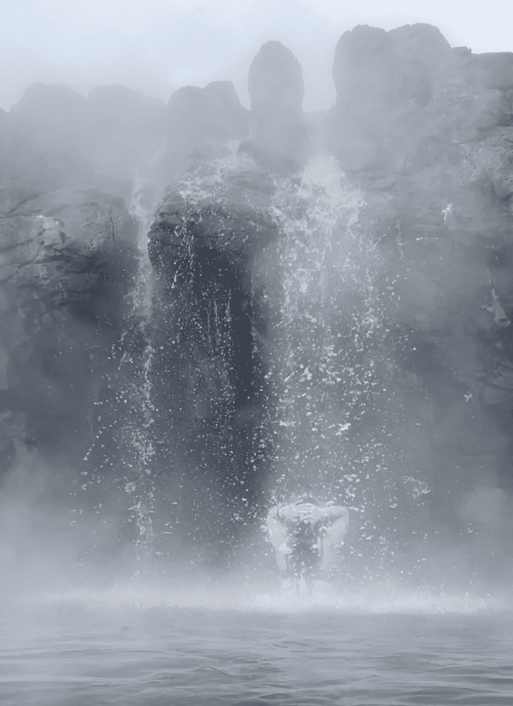 Girl under Sky Lagoon hot waterfall