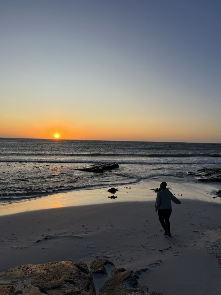 Girl running towards setting sun