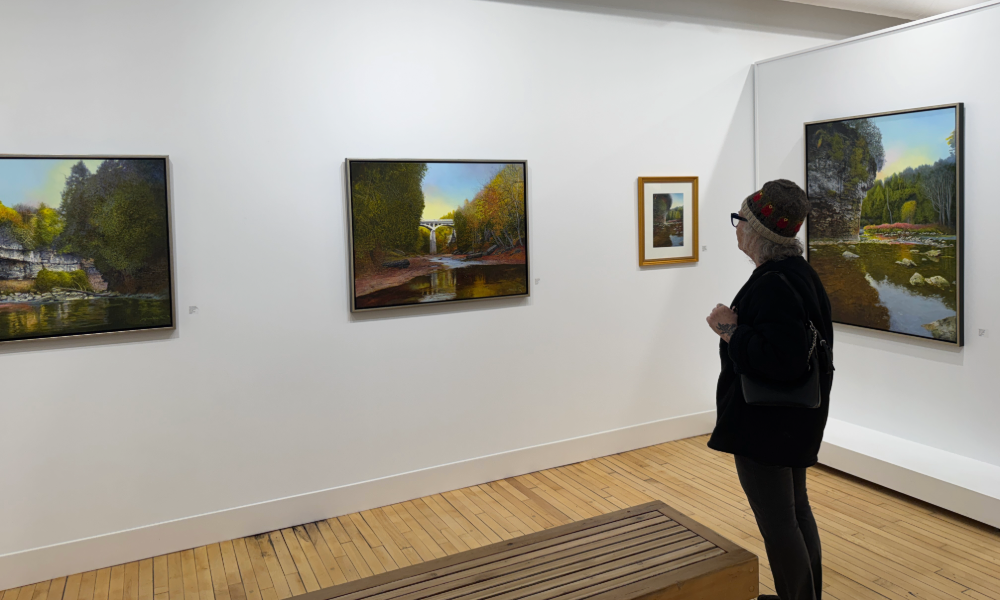 Woman looking at exhibit at the Elora Centre for the Arts