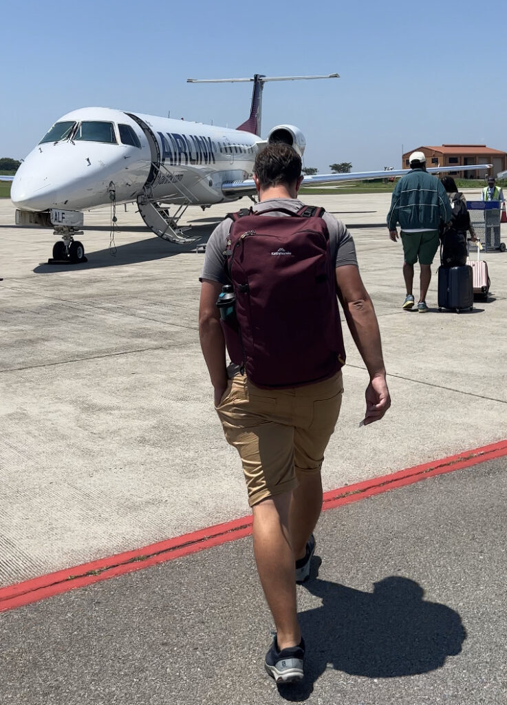 man walking towards small plane