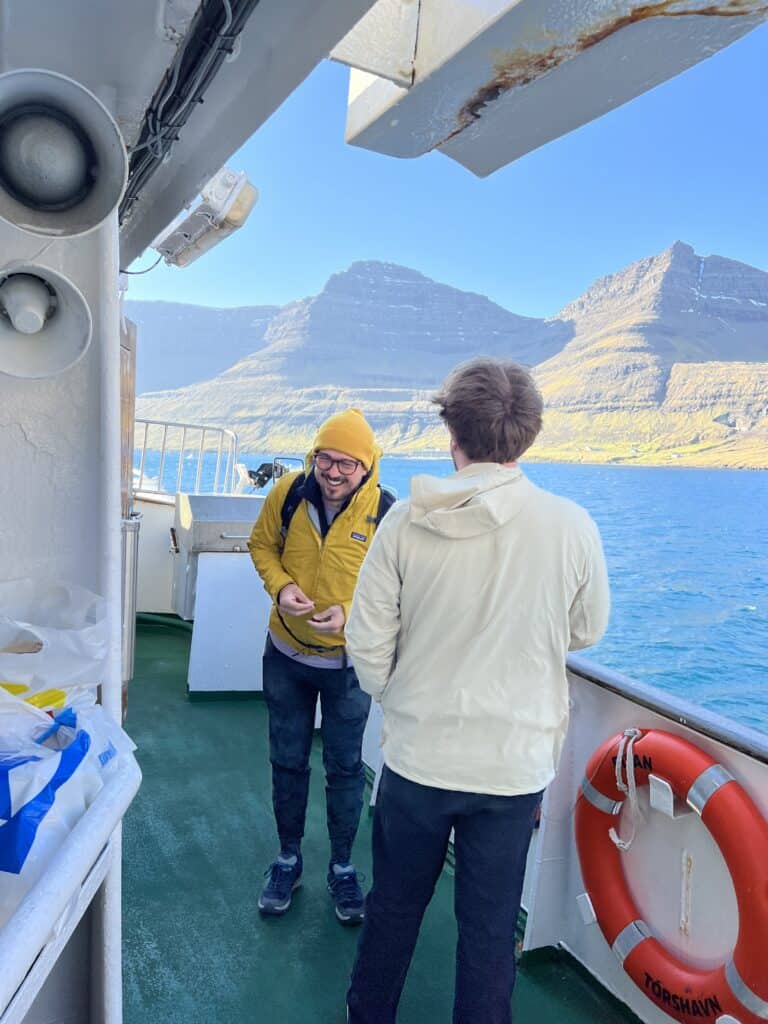 Two people laughing on a boat in the Faroe Islands