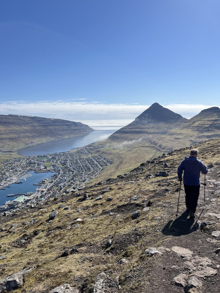 Man hiking above Klaksvik, Faroe Islands