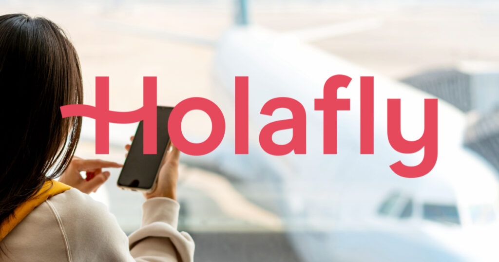 Woman using phone at the airport with Holafly logo