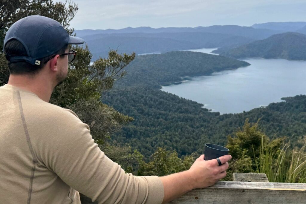 Man wearing UltraHuman Ring with lake view