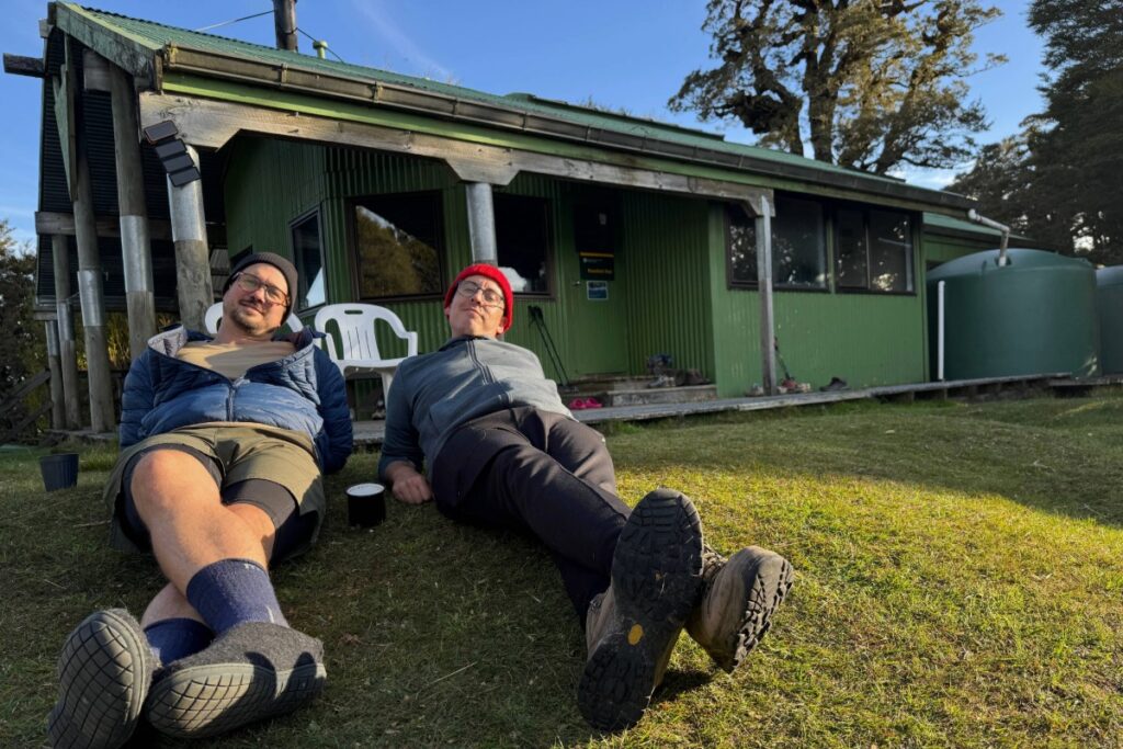 Friends outside Panekire Hut Lake Waikaremoana