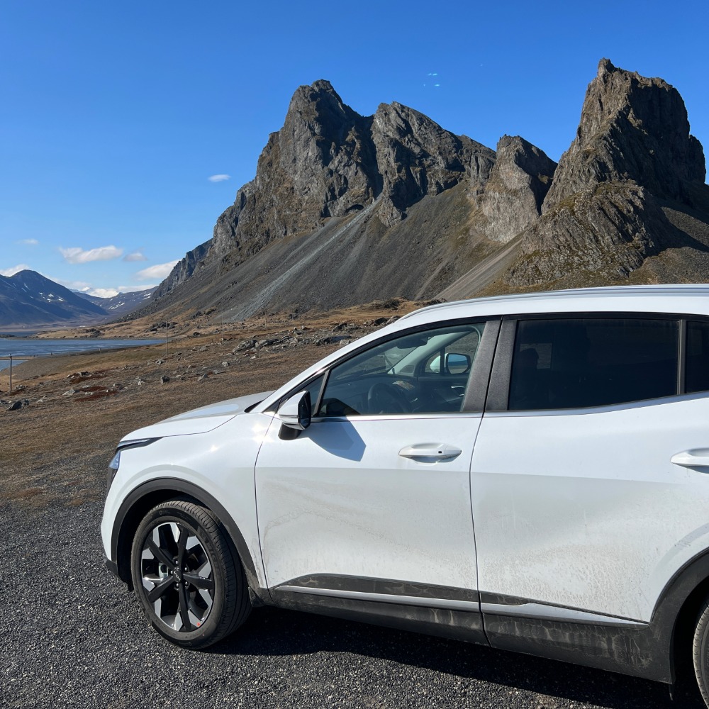 Renting a car in Iceland white SUV with mountains