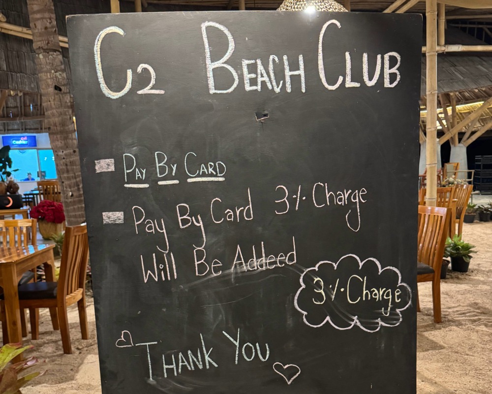 Beach club advertising a 3% charge for paying by card in Thailand
