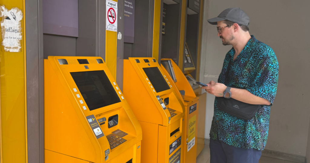 Man looking at Thai ATM Krungsri