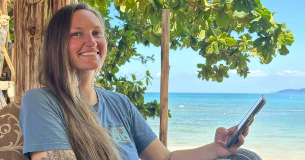 Woman using an eSIM on the beach