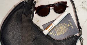 Wegovy pen in a travel bag next to a passport and sunglasses
