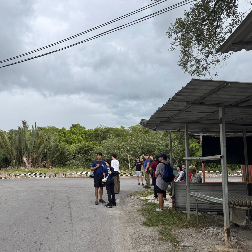 People waiting at the bus station at Bako National Park