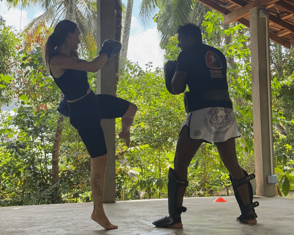 Woman mid-kick at a Muay Thai class in Hiriketiya