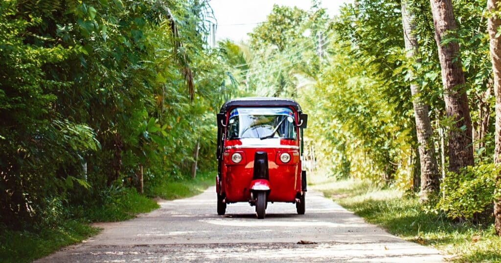 Red tuk tuk in the jungle in Sri Lanka