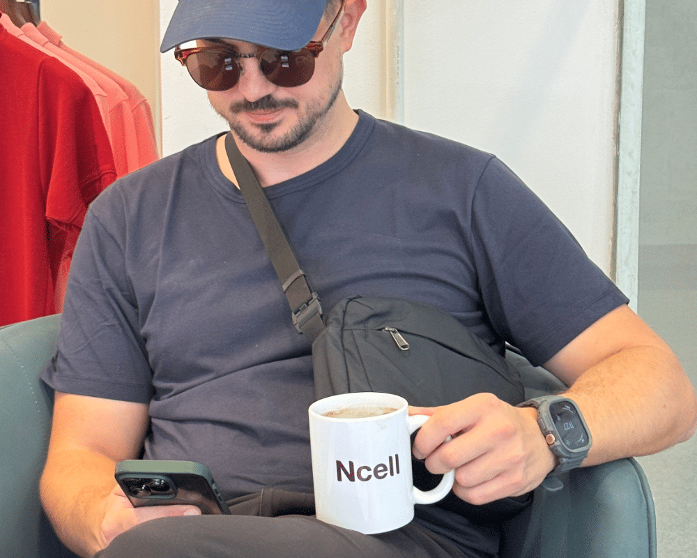 Holding an Ncell mug in Nepal